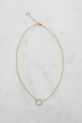 A close-up view of a delicate gold chain, showcasing its fine links and elegant shine, perfect for layering or wearing alone.