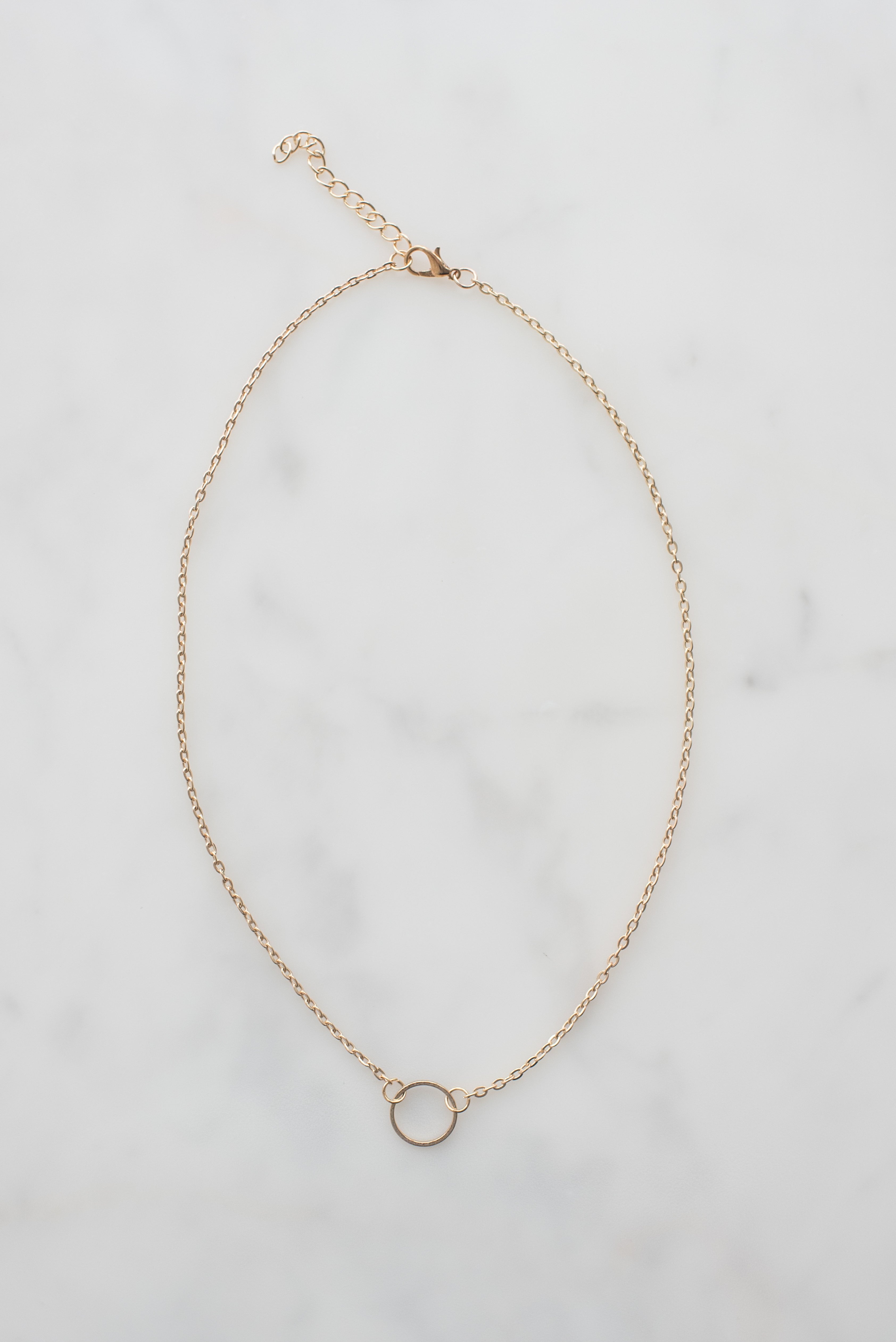 A close-up view of a delicate gold chain, showcasing its fine links and elegant shine, perfect for layering or wearing alone.
